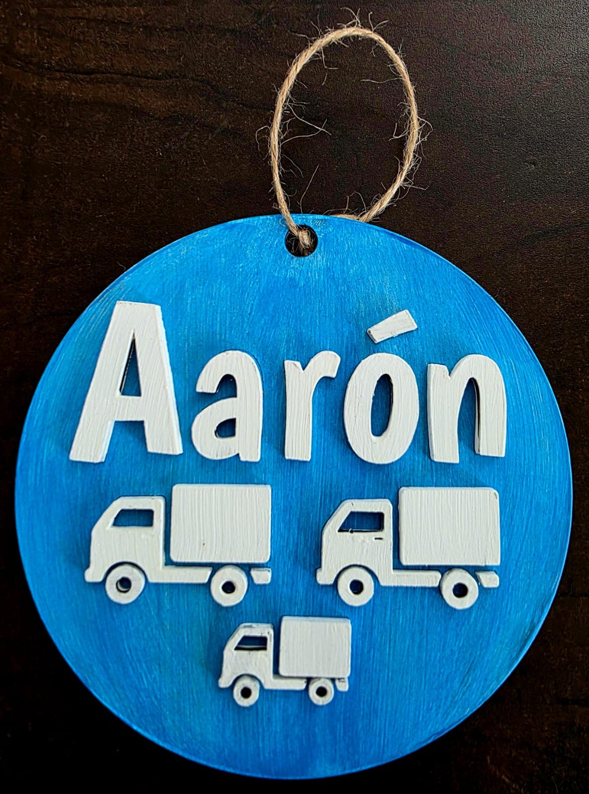 Blue hanging sign with the name Aaron